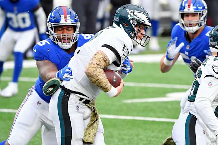 Nov 15, 2020; East Rutherford, New Jersey, USA; New York Giants defensive tackle B.J. Hill (95) tackles Philadelphia Eagles quarterback Carson Wentz (11) for a loss of yards during the first half at MetLife Stadium.